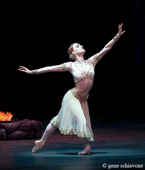 Gillian assumes a deep lunge position in a white beweled costume from the Ballet La Bayadere